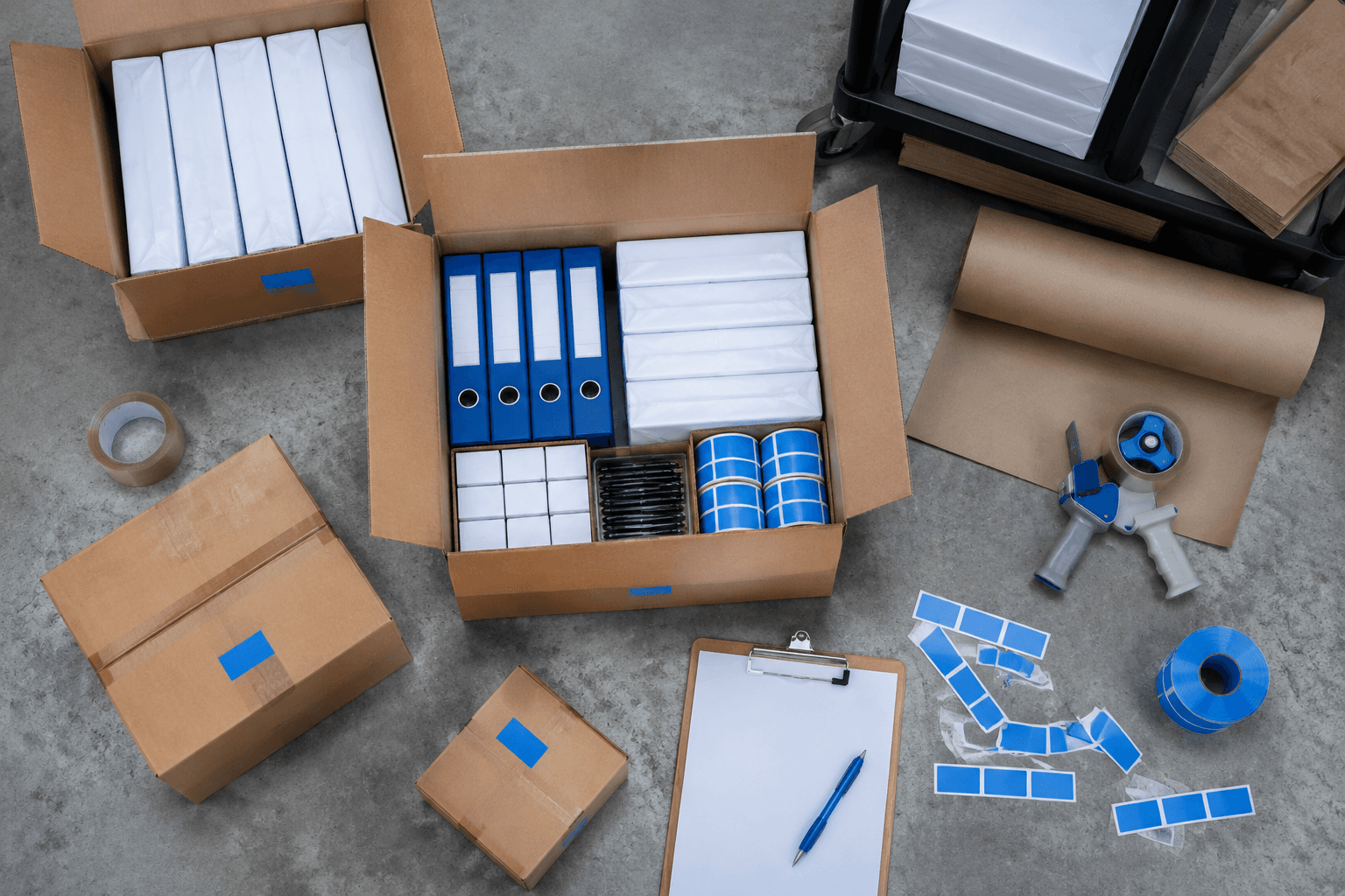 Packing desk with boxes being filled with stationery
